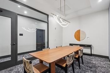 A conference room with a long table and chairs.